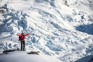 A person stands on a snowy mountain