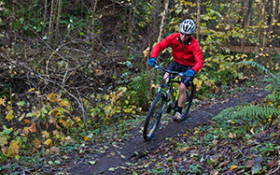 A man rides a mountain bike down a hill