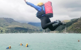 Person high jump into a lake