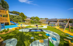 Image of a bright new playground with a girl playing