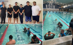 college of people standing round a swimming pool