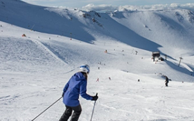 A person skis down a snowy hill at Mt Hutt skifield