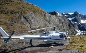 A helicopter sits on top of a mountain 