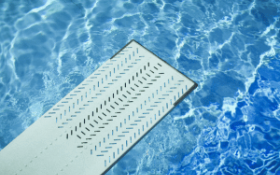 A pool diving board with water below