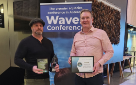 Two men stand holding awards they have won in the Aquatics Awards 2024